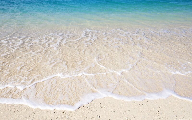 Calm waves on a sandy beach