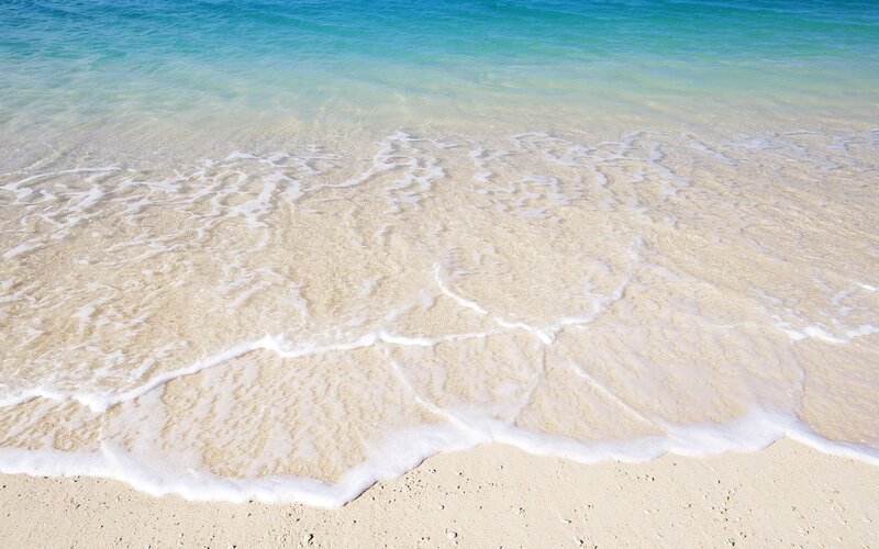 Calm waves on sandy beach