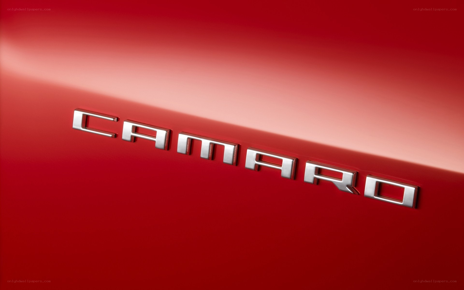 Camaro emblem on red car