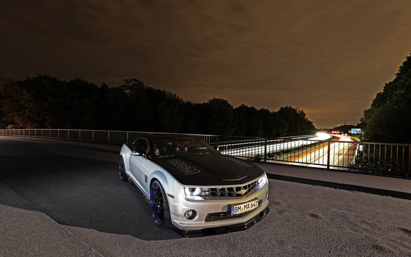 Camaro on a bridge at night