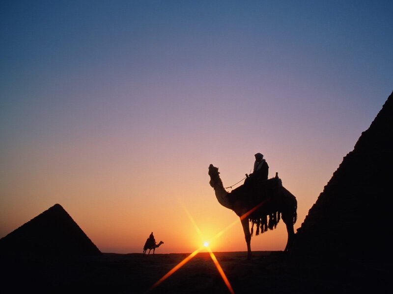 Camel Riders at Sunset — Orange, Dramatic, Photograph