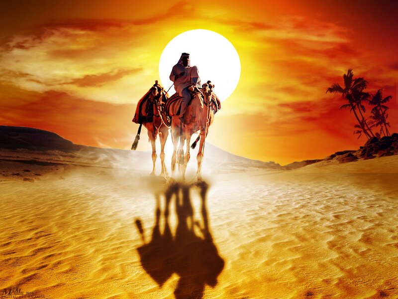 Camel riders at sunset