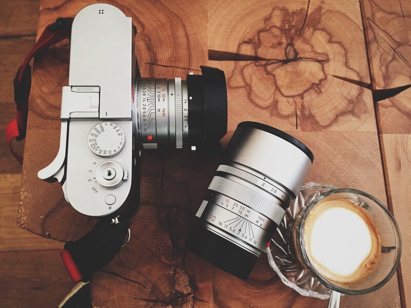 Camera and coffee on wood