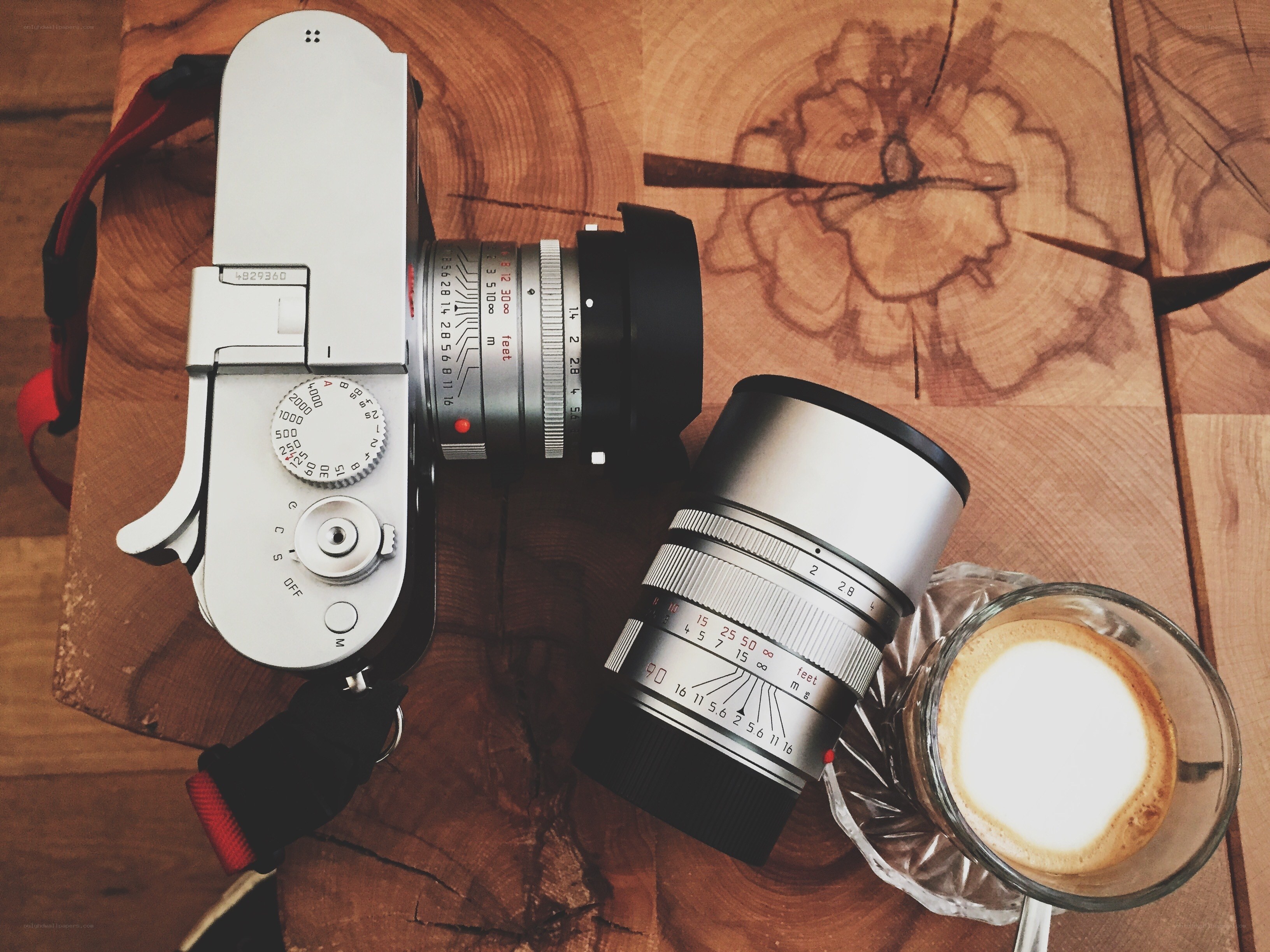 Camera and coffee on wood