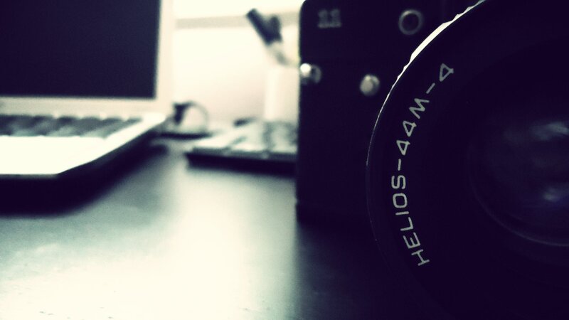 camera and laptop on desk