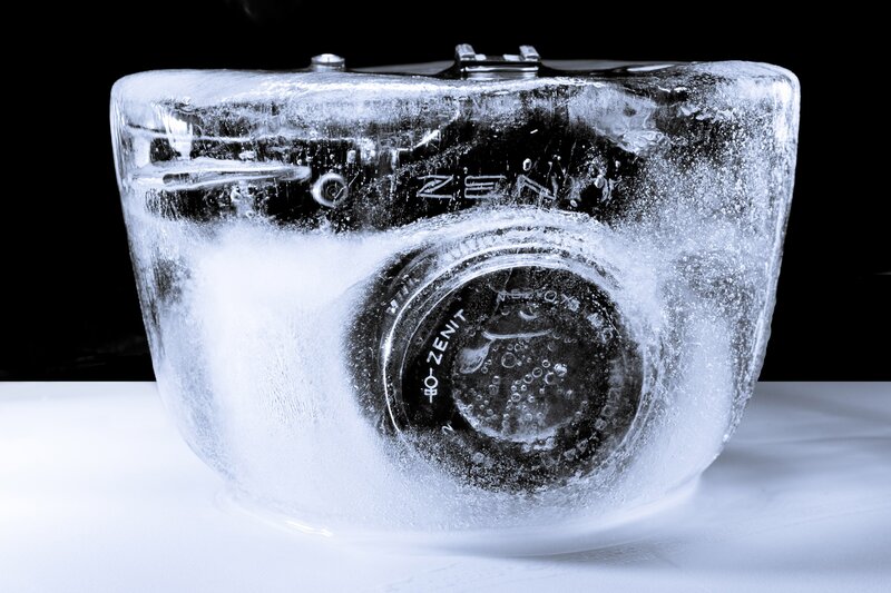 Camera in Ice Block — White, Dramatic