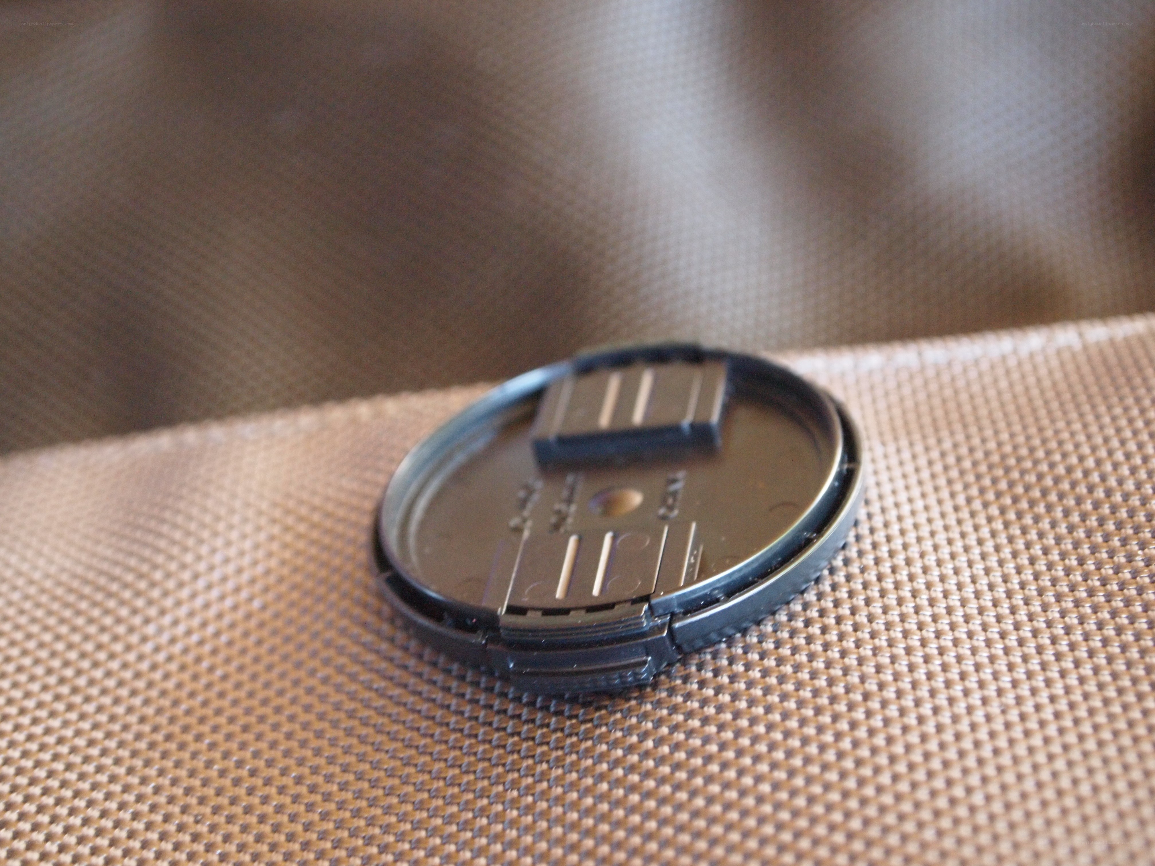 camera lens cap on fabric