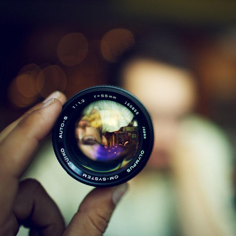 Camera Lens in Hand — Black, Intimate, Night