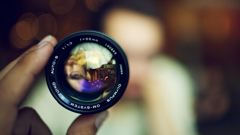 Camera Lens in Hand — Black, Intimate, Photograph