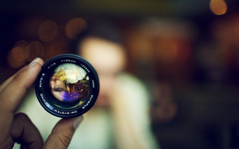 Camera Lens in Hand