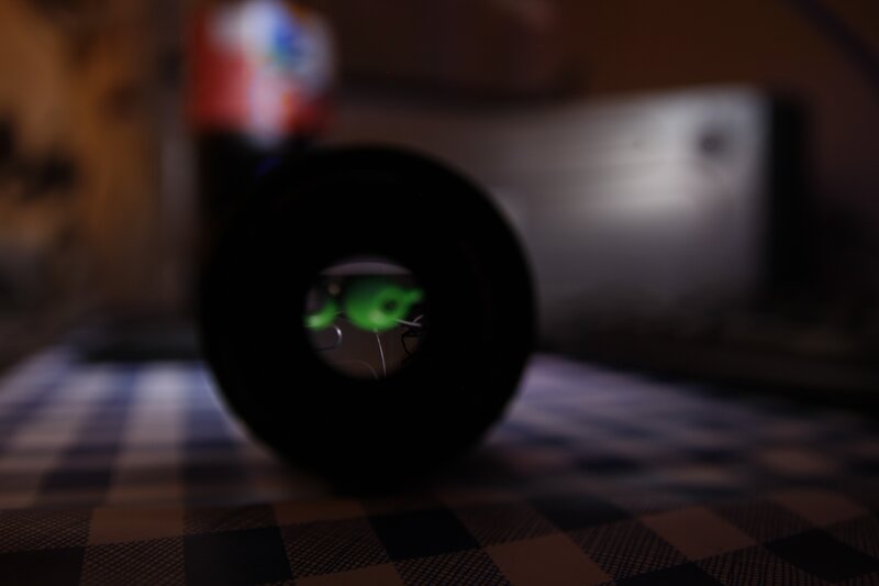 camera lens on checkered surface