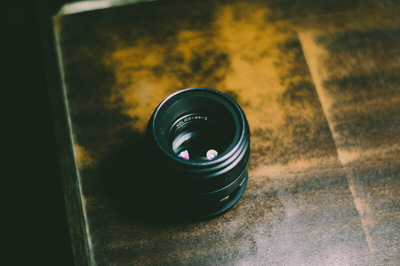 Camera Lens on Table — Black