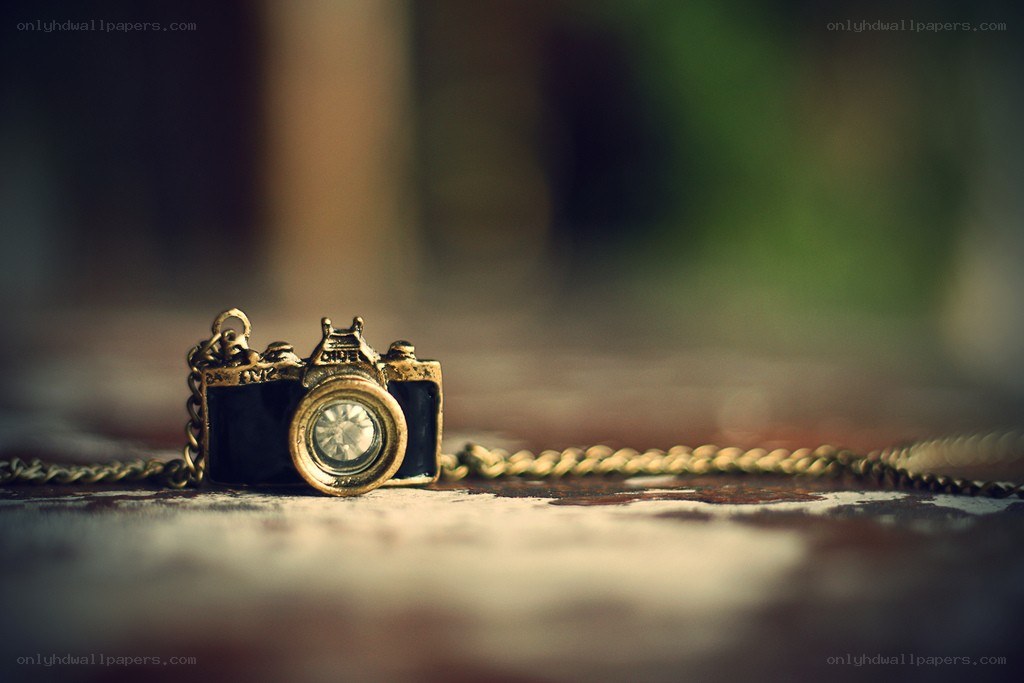 camera necklace on wooden surface
