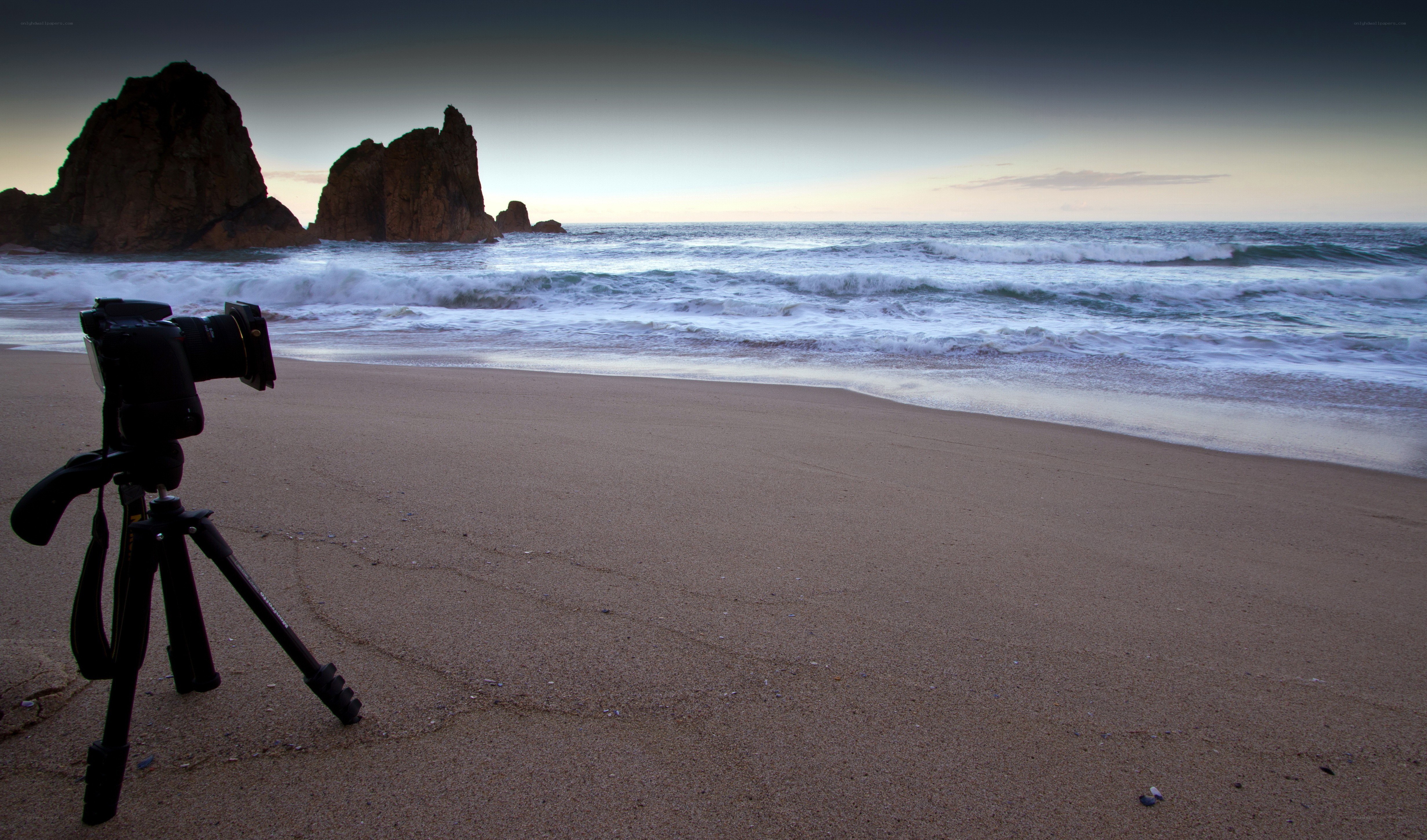 Camera on beach at sunset