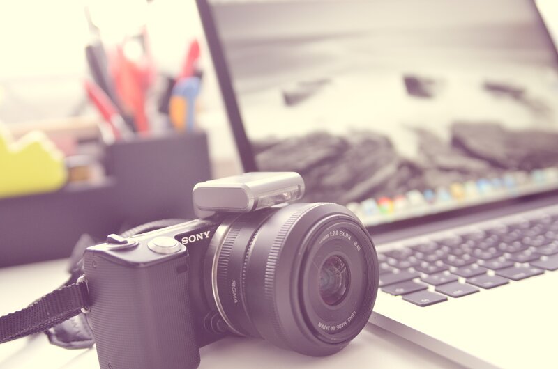 camera on desk with laptop