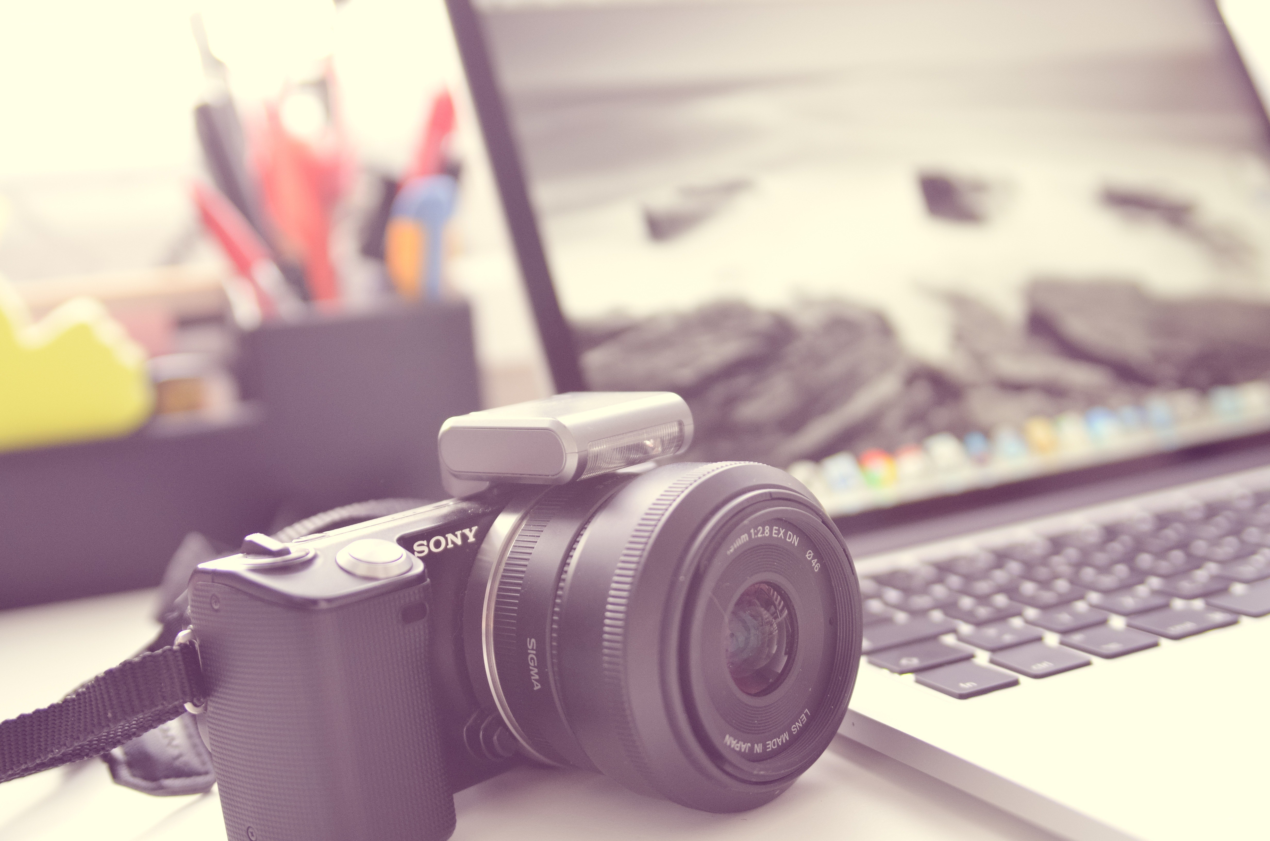 camera on desk with laptop