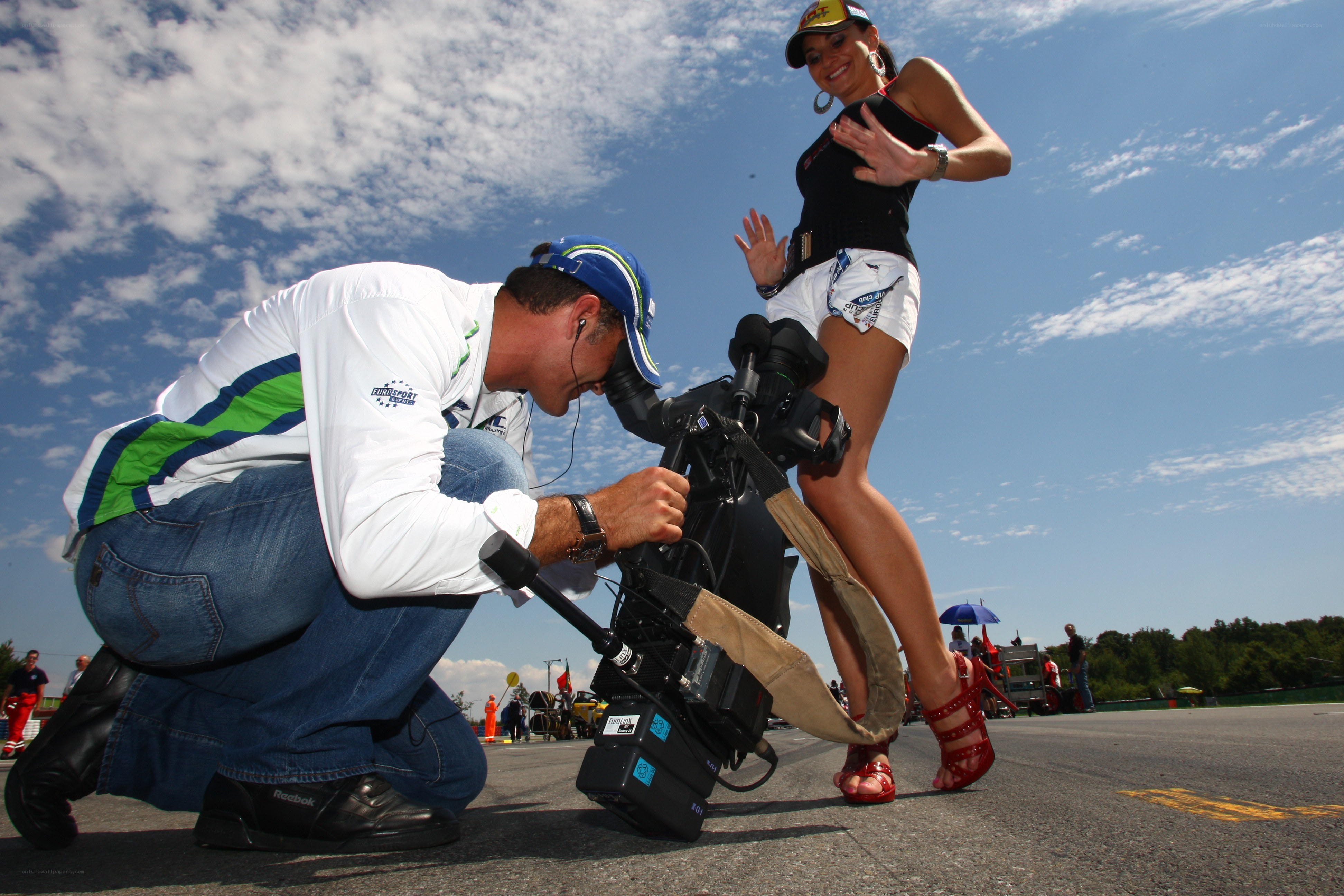 Camera operator filming a woman on track