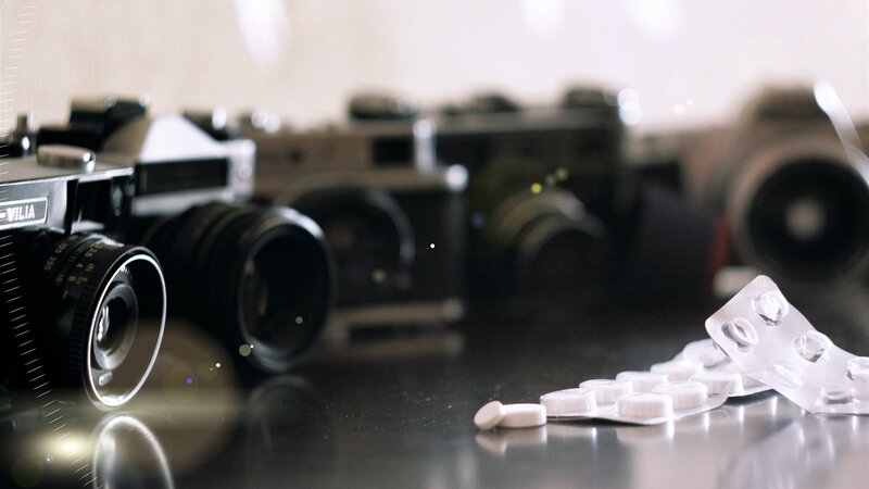 Cameras and pills on a table