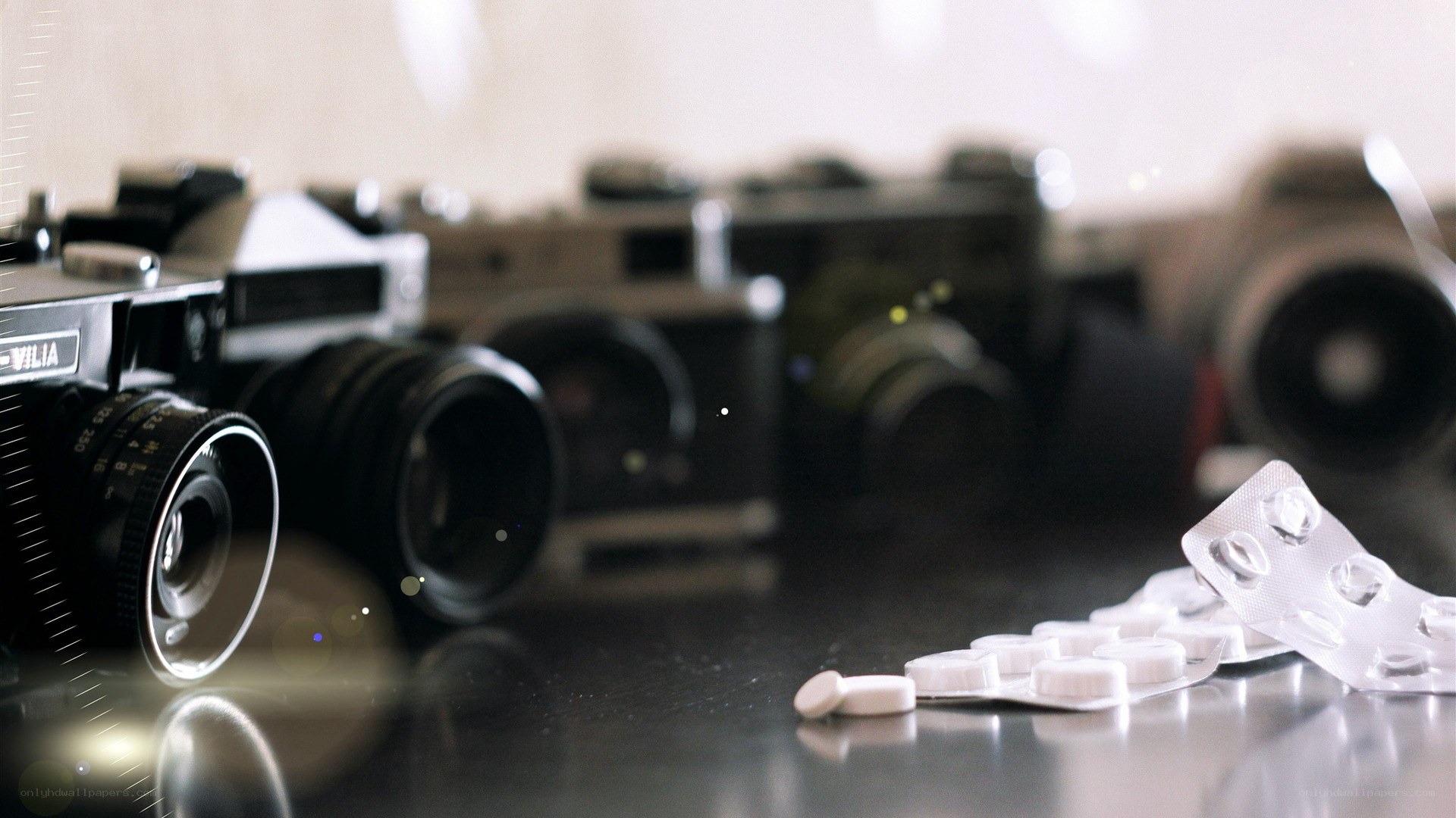 Cameras and pills on a table
