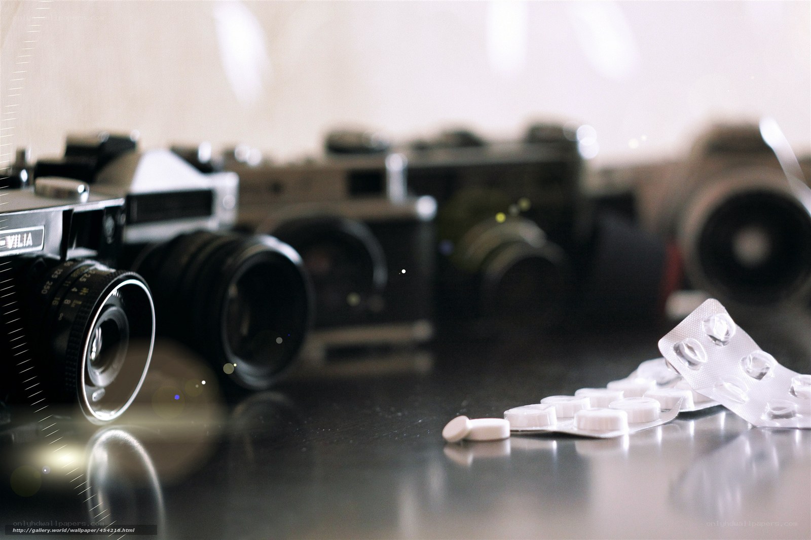 Cameras and pills on a table