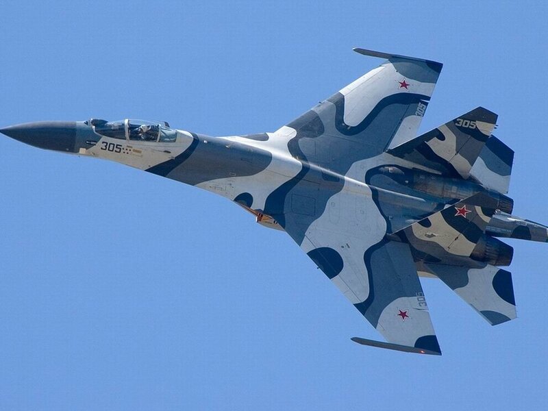 camouflage fighter jet in flight