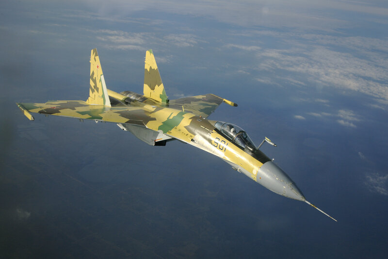camouflage fighter jet in flight