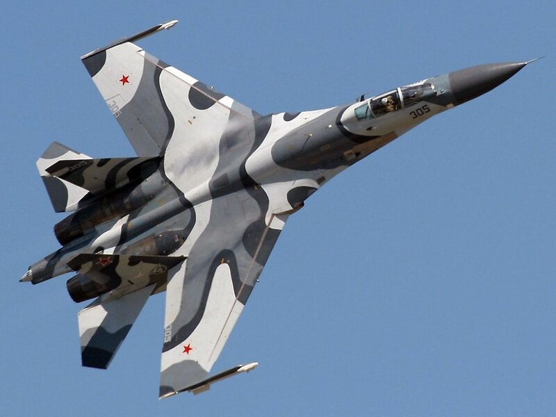 camouflage fighter jet in flight