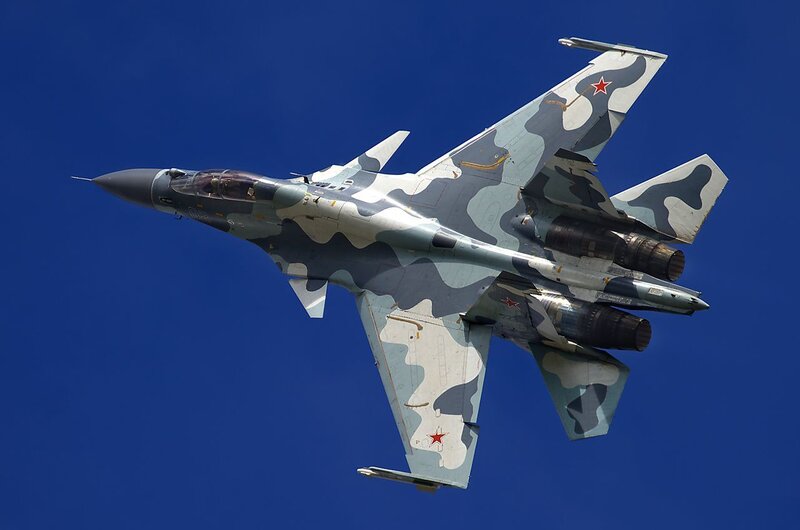 camouflage fighter jet in flight