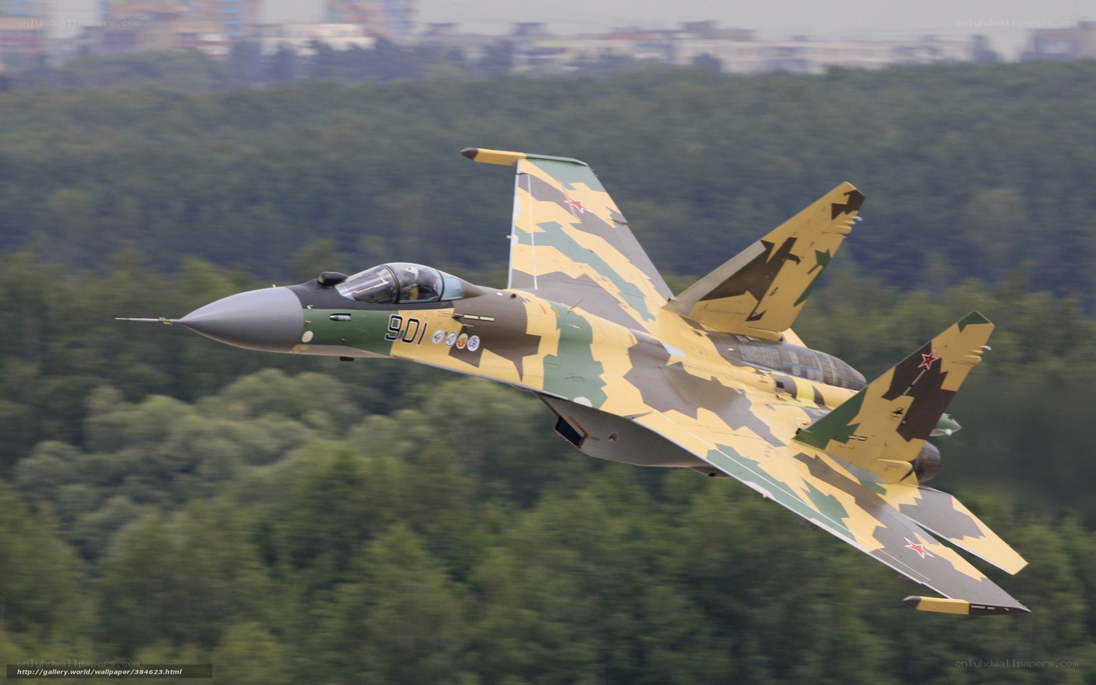 camouflage fighter jet in flight