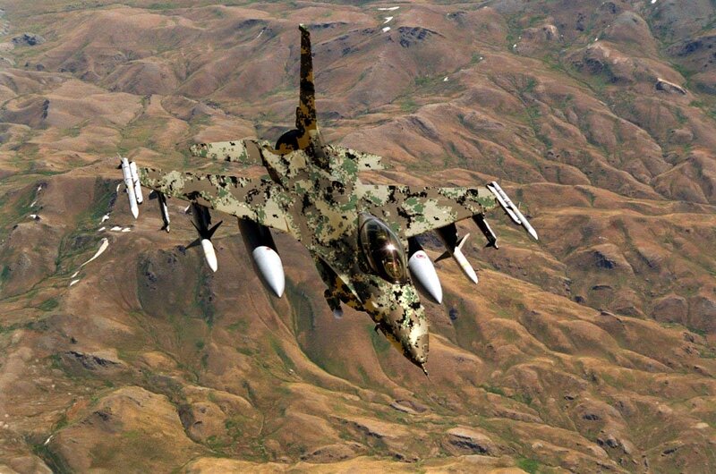 camouflage fighter jet in flight