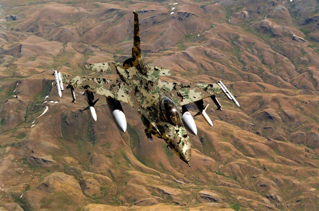 camouflage fighter jet in flight