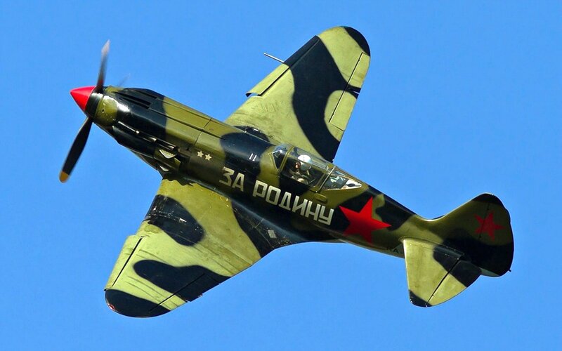 Camouflage Fighter Plane — Blue, Dynamic, Afternoon