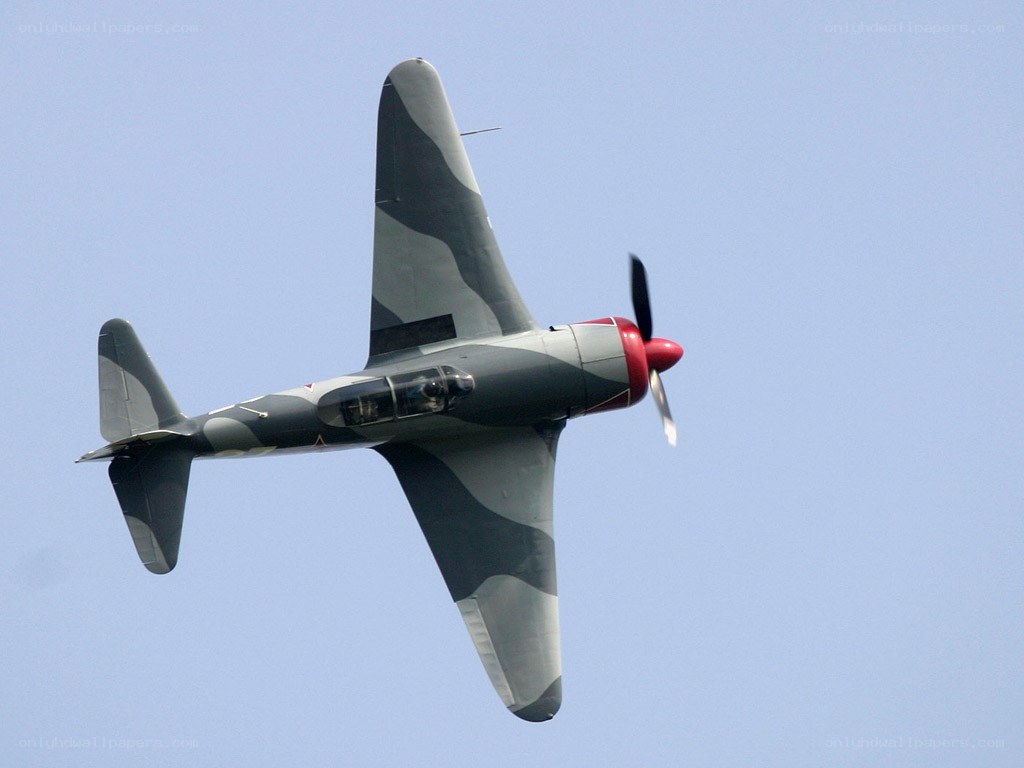 camouflage fighter plane in flight
