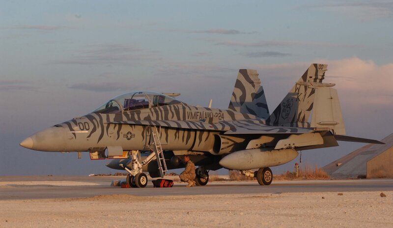 camouflage jet on tarmac