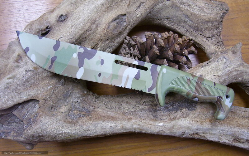 camouflage knife on driftwood