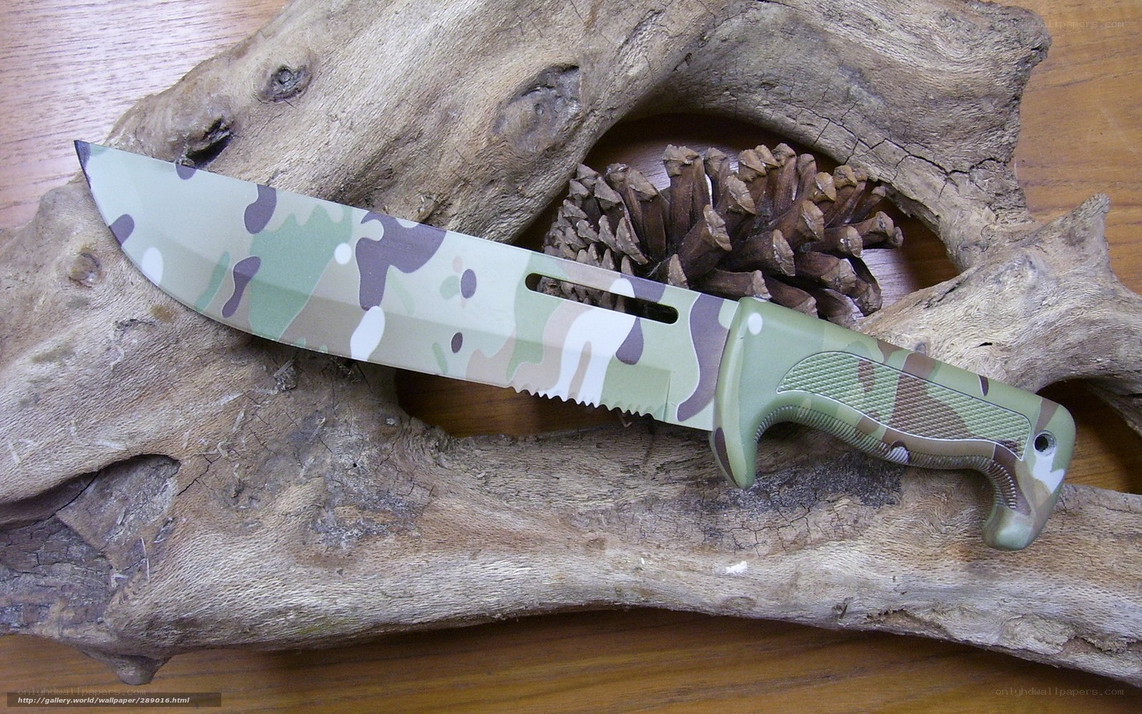camouflage knife on driftwood