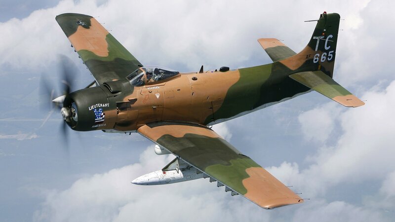 camouflage military aircraft in flight