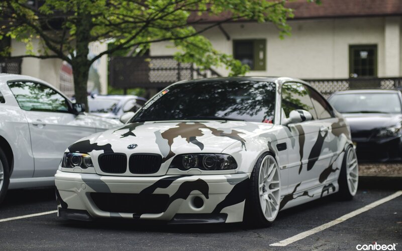 camouflage-painted BMW in parking lot