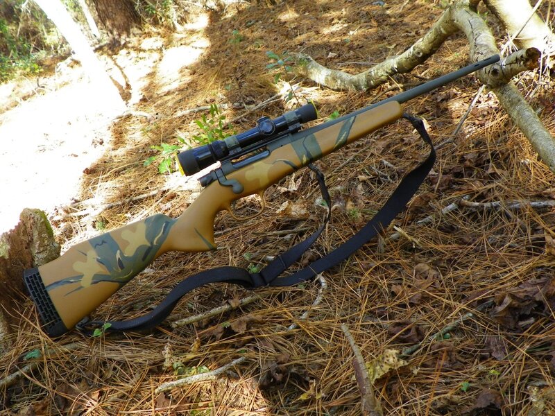 Camouflage Rifle in Forest