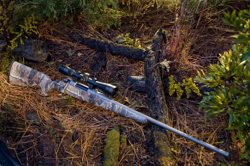 Camouflage Rifle on Forest Floor