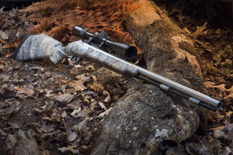 Camouflage Rifle on Log
