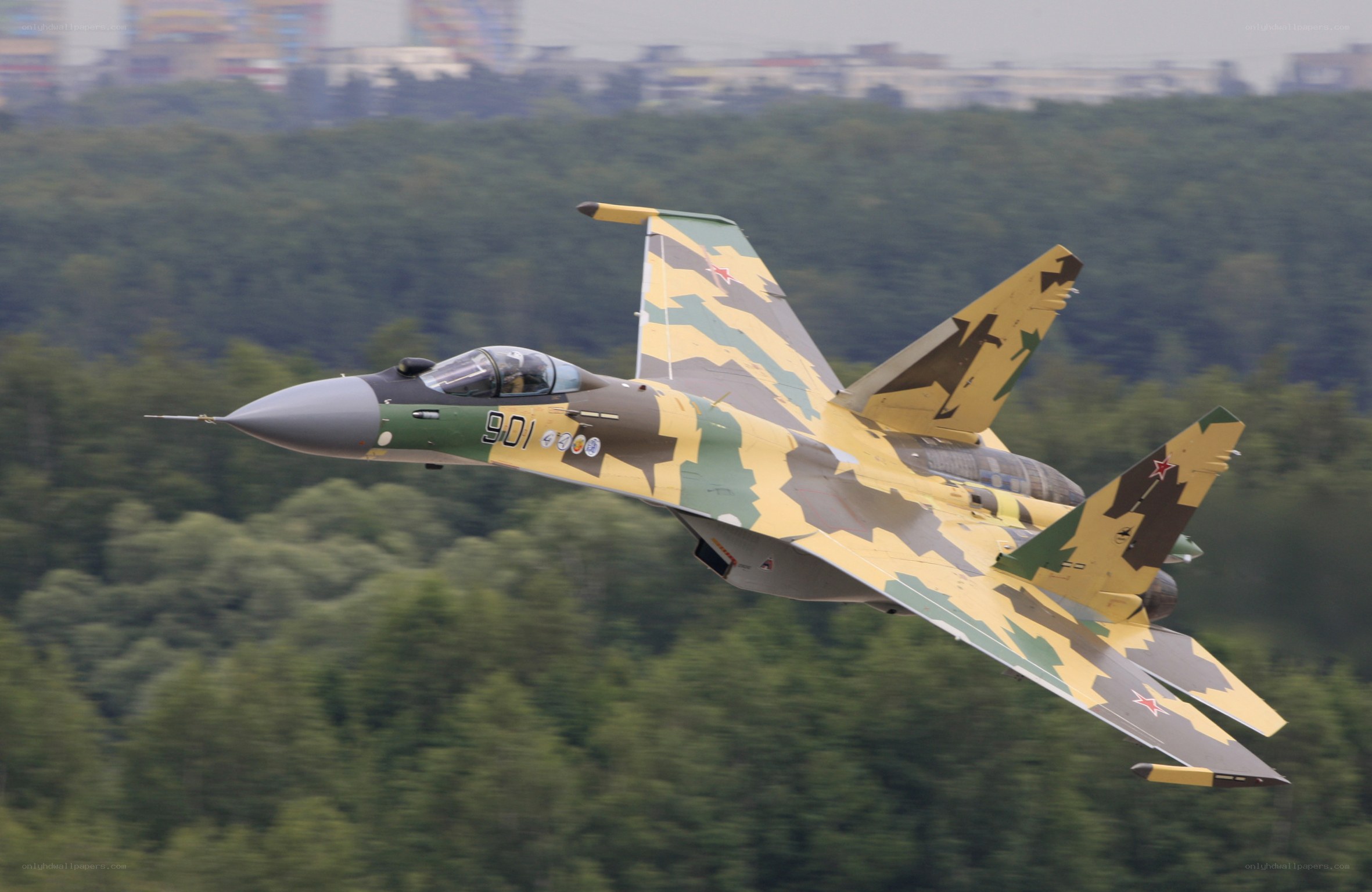 camouflaged fighter jet in flight