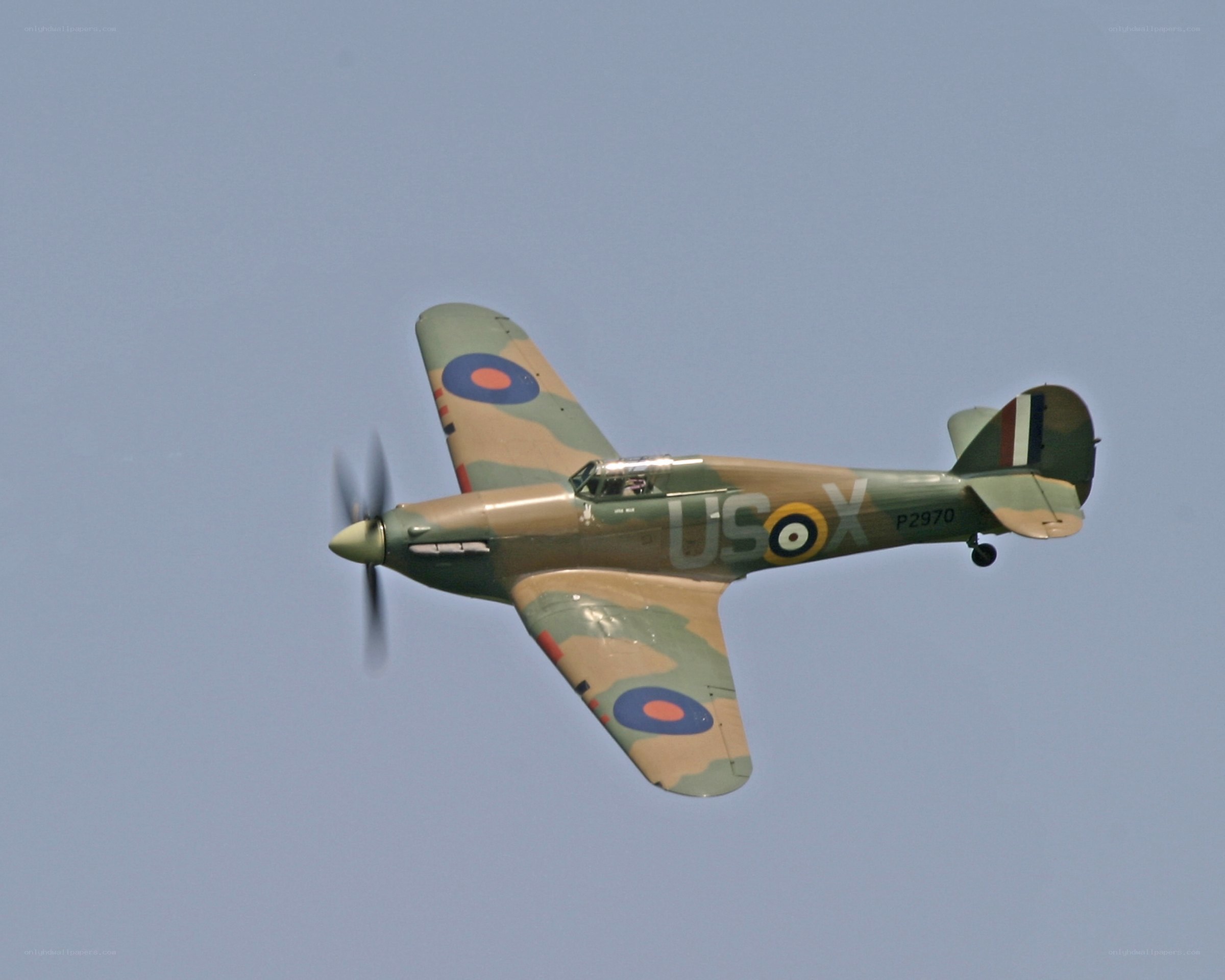 Camouflaged fighter plane in flight