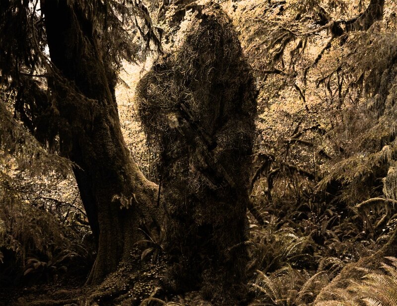 camouflaged figure in forest