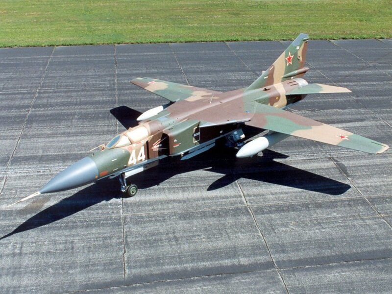 camouflaged military jet on tarmac