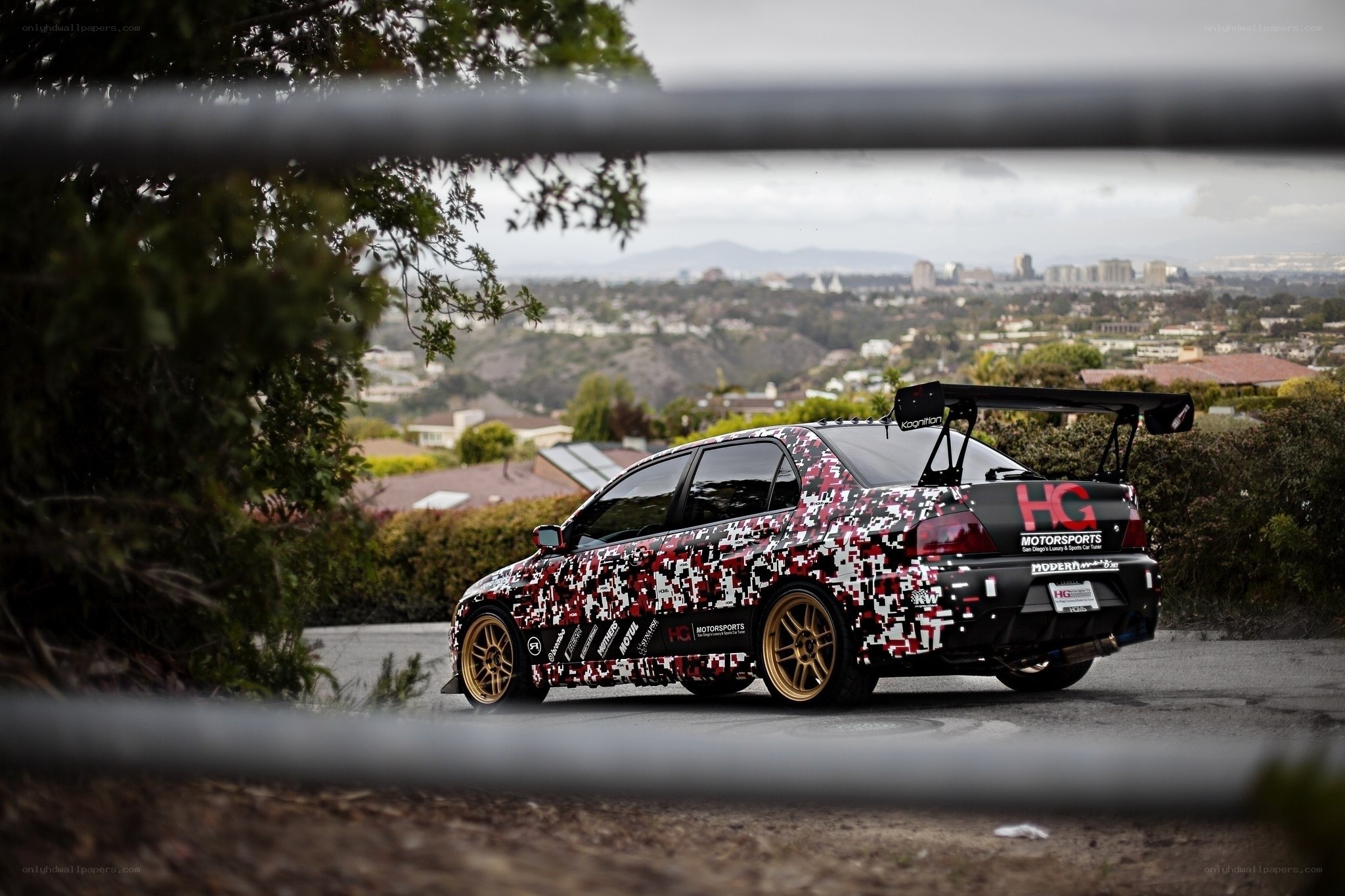 camouflaged race car on hillside