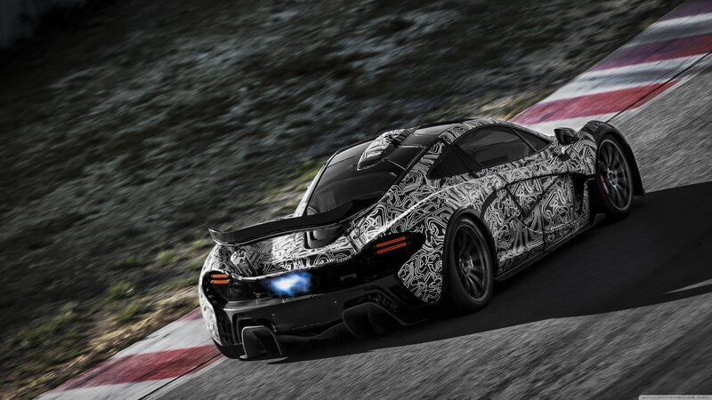 camouflaged sports car on track