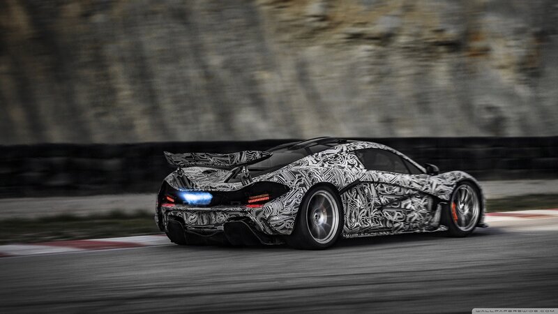 camouflaged sports car on track