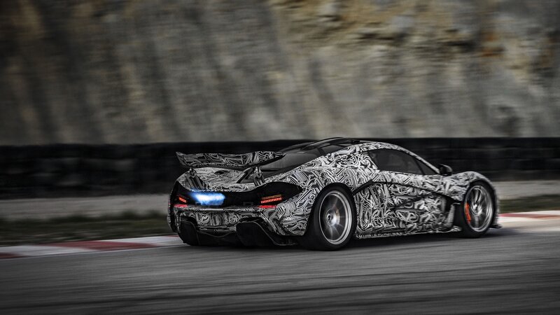 camouflaged sports car on track