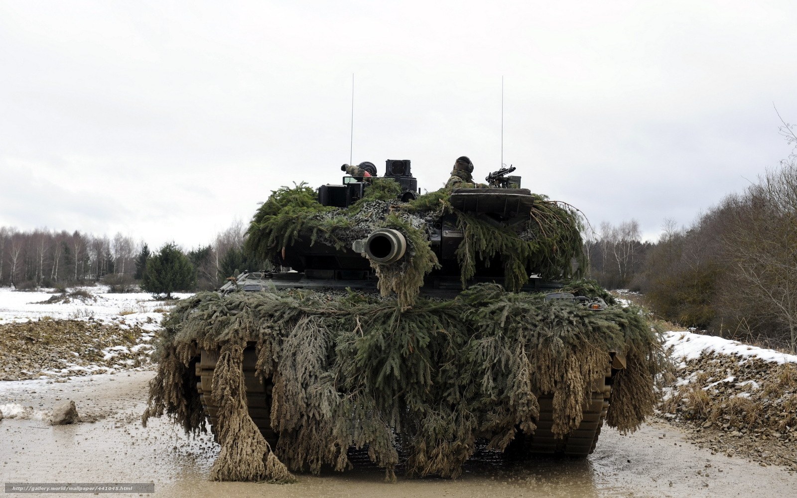 Camouflaged tank in winter field